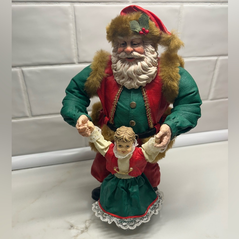 Santa Claus dancing with little girl figure